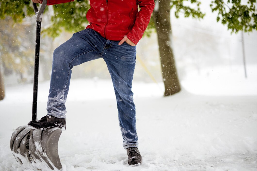 'I'd Cut That!' team member shoveling snow with dedication."