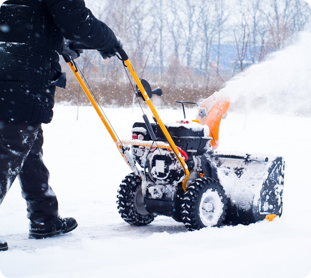 Professional at 'I'd Cut That!' efficiently removing snow in Calgary with sophisticated equipment.